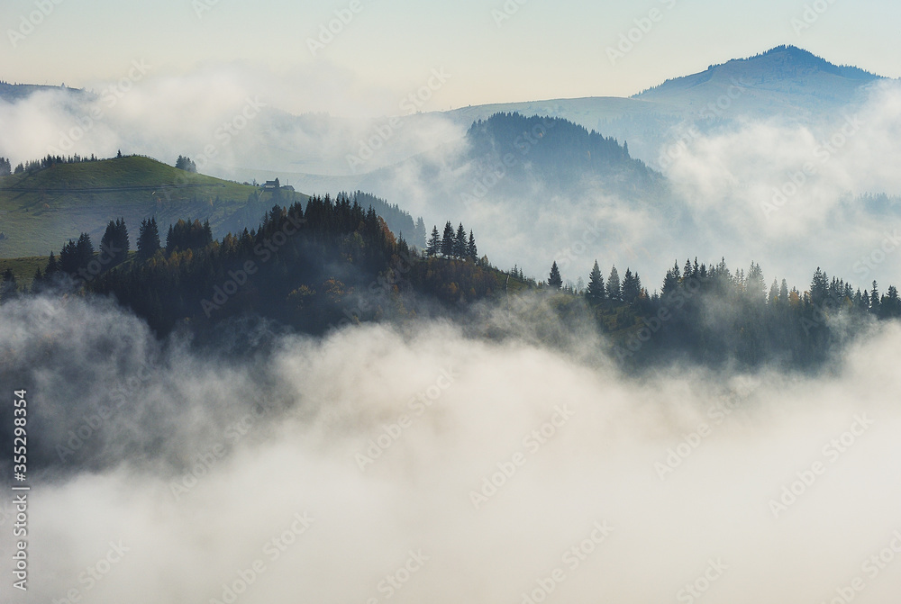 Fototapeta premium Predawn time in the highlands. mountain silhouettes in the fog