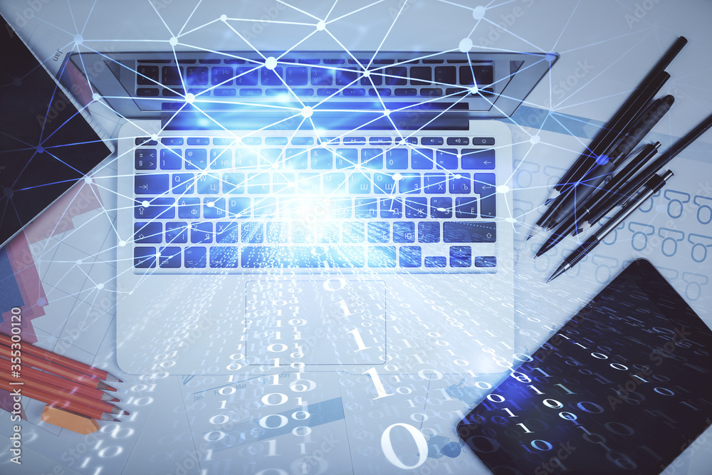 Multi exposure of data drawing hologram over topview of study desk background with computer. Concept of technology. Multi exposure of data drawing hologram over topview of study desk background with computer. Concept of technology.
