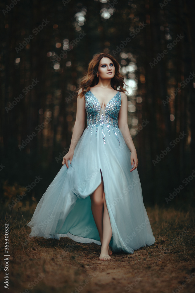 beautiful girl posing in soft blue dress in the forest beautiful girl posing in soft blue dress in the forest