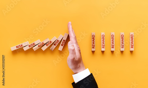 risk reward concept. the man stops falling blocks with the inscription risk and builds blocks with the inscription reward