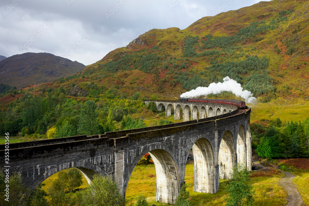 Jacobite Steam Train crossing the Glenfinnan Viaduct in the highlands of Scotland