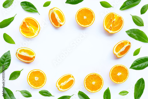 High vitamin C, Juicy and sweet. Frame made of fresh orange fruit with green leaves on white background.