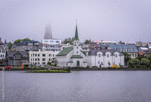 Free Church and National Gallery located on the shore of Lake Tjornin in Reykjavik city, Iceland photo