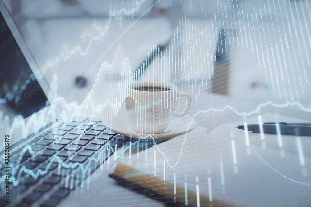 Double exposure of financial chart drawing and desktop with coffee and items on table background. Concept of forex market trading