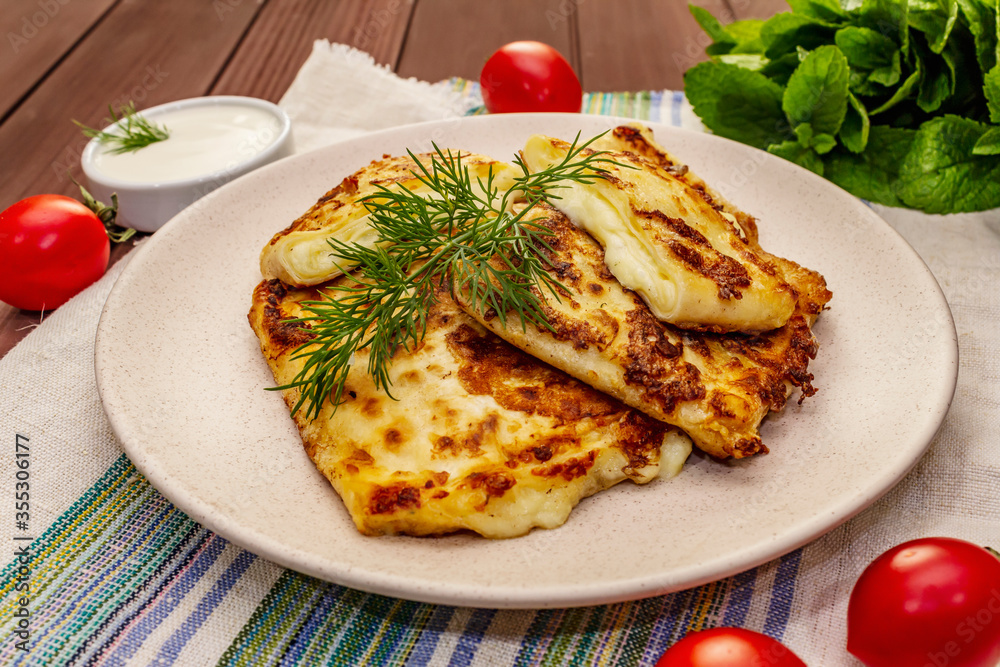 Hot appetizer - pita bread with cheese and herbs. Vegetarian healthy food Hot appetizer - pita bread with cheese and herbs. Vegetarian healthy food