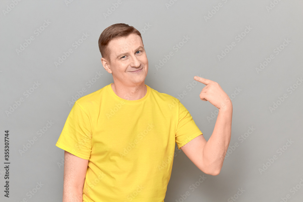 Portrait of happy man pointing with finger at himself and smiling Portrait of happy man pointing with finger at himself and smiling