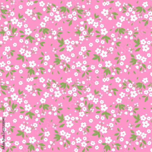 Vintage floral background. Seamless vector pattern for design and fashion prints. Flowers pattern with small white flowers on a pink background. Ditsy style.  © ann_and_pen
