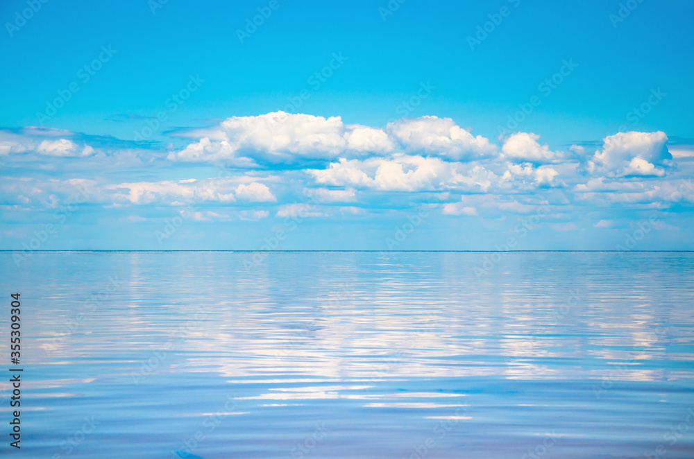 Seascape background vivid blue sky with clouds reflect in sea