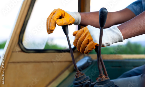 man using operator scoop with old and dirty gloves photo