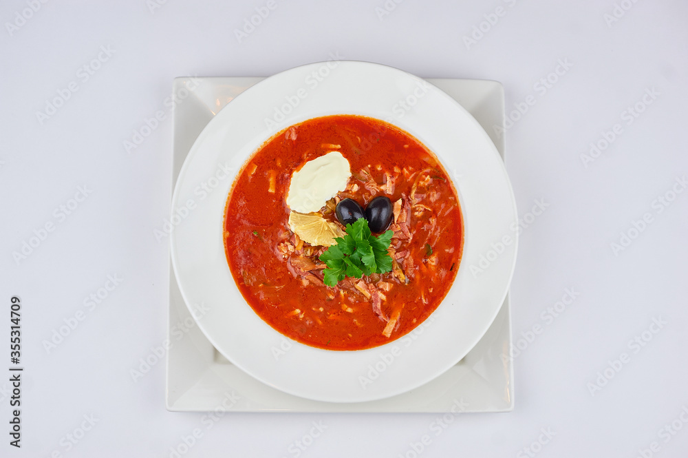 borscht on the table in a white plate and on a white background borscht on the table in a white plate and on a white background