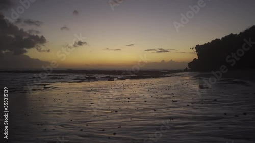 Beautiful sunset sky and reflection over the beach sand in Bali (slow motion 120fps)