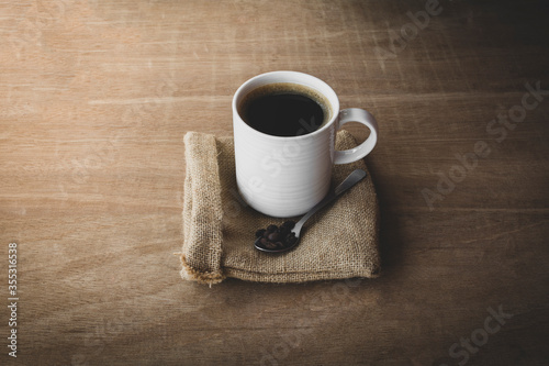 black coffee in a coffee cup top view isolated on wood background.
