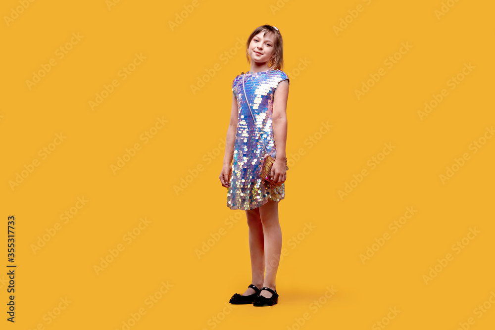 In full height smiling dancing cute girl looks into the camera. Holiday dress In full height smiling dancing cute girl looks into the camera. Holiday dress
