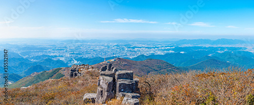 Gwangju viewed behind rocks of Jusangjeolli Cliff at Mudeungsan Mountain, Republic of Korea photo