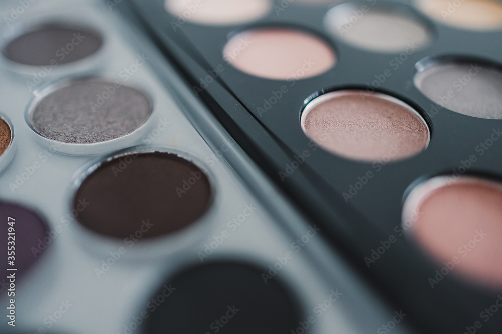 cosmetics and beauty, close-up of two similar eyeshadow palettes with neutral nude tones next to each other metaphor of competition cosmetics and beauty, close-up of two similar eyeshadow palettes with neutral nude tones next to each other metaphor of competition