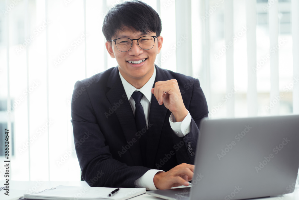 Attractive asian smiling businessman in office place, Confident young man. Attractive asian smiling businessman in office place, Confident young man.