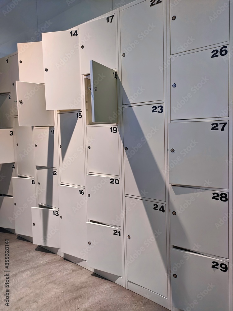 Locker room with rows of numbered lockers for personal belongings Locker room with rows of numbered lockers for personal belongings