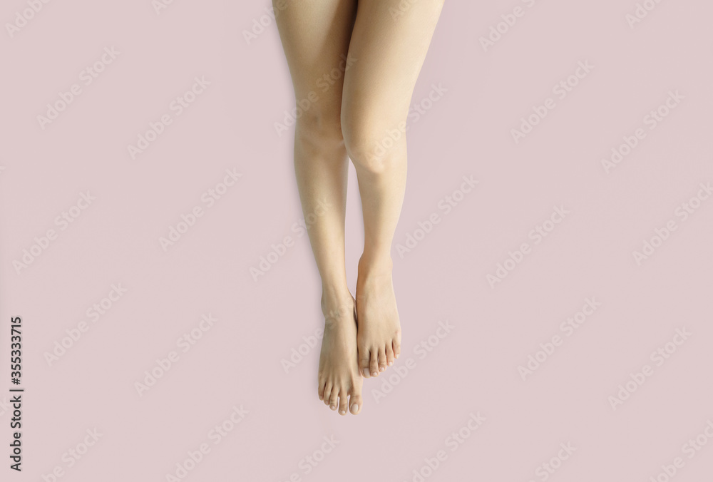 Beautiful perfect woman legs and feet on a white background.Concept beauty and hydration of the skin. Beautiful perfect woman legs and feet on a white background.Concept beauty and hydration of the skin.