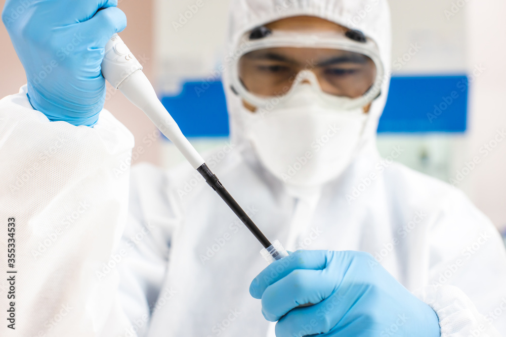 Scientists in PPE Work in an infection prevention room Scientists in PPE Work in an infection prevention room