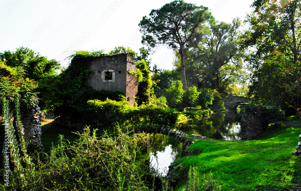 Garden of Ninfa: detail of ruins and stone bridges on the river