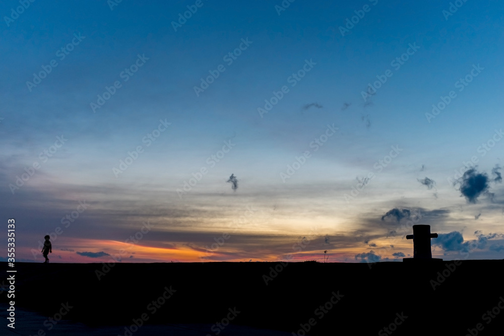 silhouette twilight sky of a cross pole with human