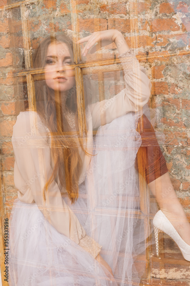 Fototapeta premium Girl in a white tutu in a city garden