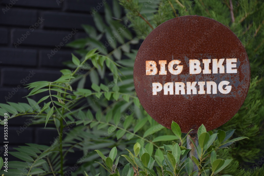 sign for big bike parking at the coffee  shop.