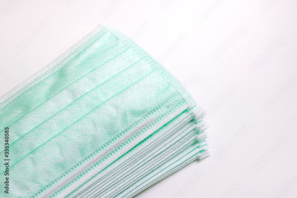 Surgical mask for protect against COVID-19 Coronavirus. Disposable mask is used for protects against virus, pollen, dust or microparticles in the air. Hygiene concept isolated on white background. Surgical mask for protect against COVID-19 Coronavirus. Disposable mask is used for protects against virus, pollen, dust or microparticles in the air. Hygiene concept isolated on white background.