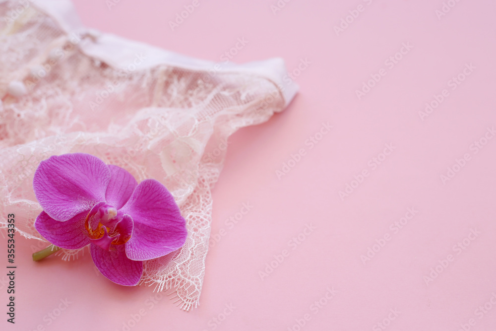 beautiful lingerie on a pink background with an orchid flower, beautiful lingerie on a pink background with an orchid flower,