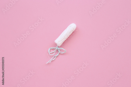 white hygiene tampon on a pink background