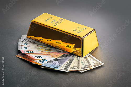 Gold bullion and banknotes of dollars and euros.