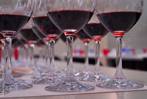 Close up view of rows of red wine glasses