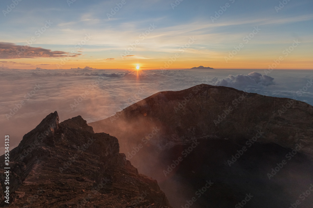 sunrise at the top of agung volcano. crater view. Higher than clouds. rinjani view. High quality photo. Bali - island of gods. Indonesian mountains. trekking rote to summit. 
