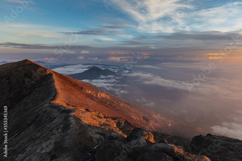 sunrise at the top of agung volcano. crater view. Higher than clouds. Kintamani view. High quality photo. Bali - island of gods. Indonesian mountains. trekking rote to summit. Batur and Abang