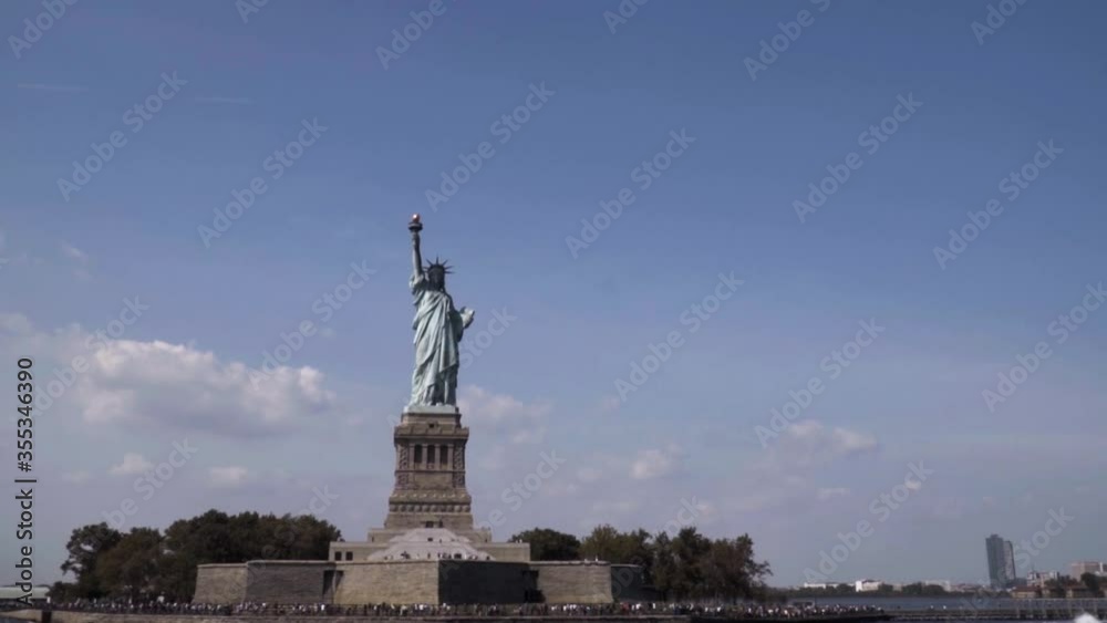 Slow Motion view from Manhattan on the Statue of Liberty National Monument on Liberty Island in New York Harbor in New York, in the United States. Slow Motion view from Manhattan on the Statue of Liberty National Monument on Liberty Island in New York Harbor in New York, in the United States.
