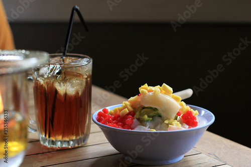 Es Campur or Es Oyen is Mix Fruit with Shaved Ice Served on a Bowl Popular Dessert in Bandung West Java photo