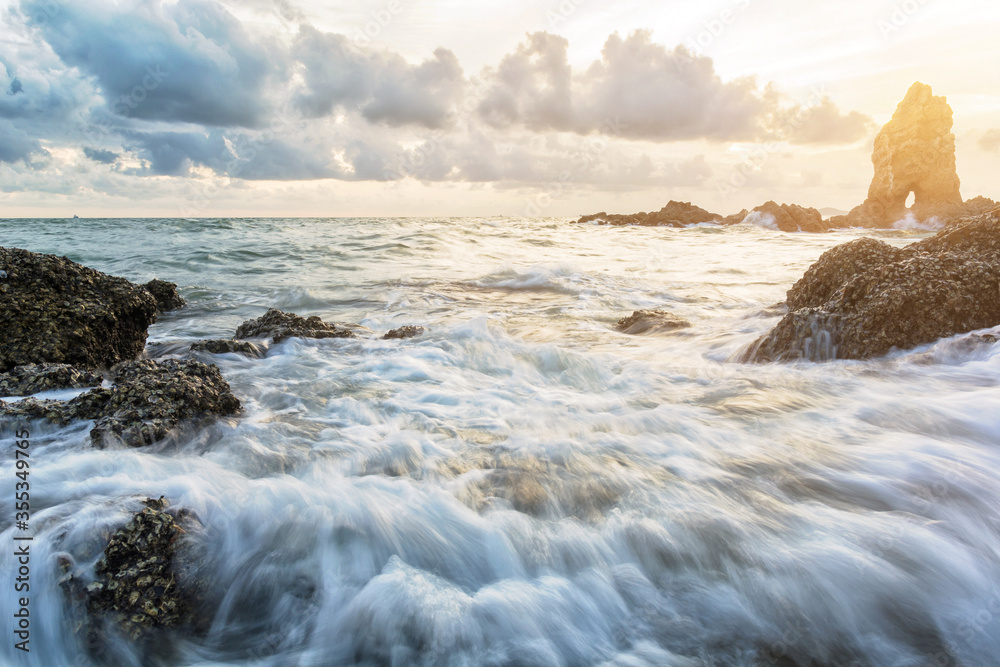 Fototapeta premium Motion of sea with large rocks near land