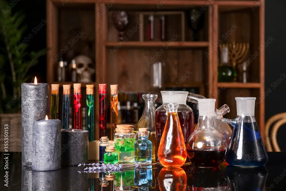Different potions on alchemist's table Different potions on alchemist's table