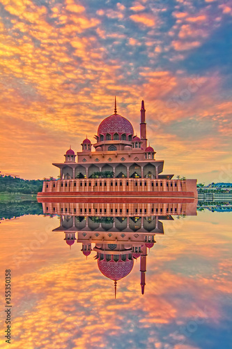 Beautiful architectural design of Putra Mosque with magnificient sunrise at the background photo