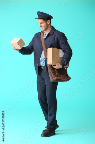 Handsome young postman on c...