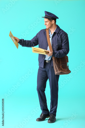 Handsome young postman on c...