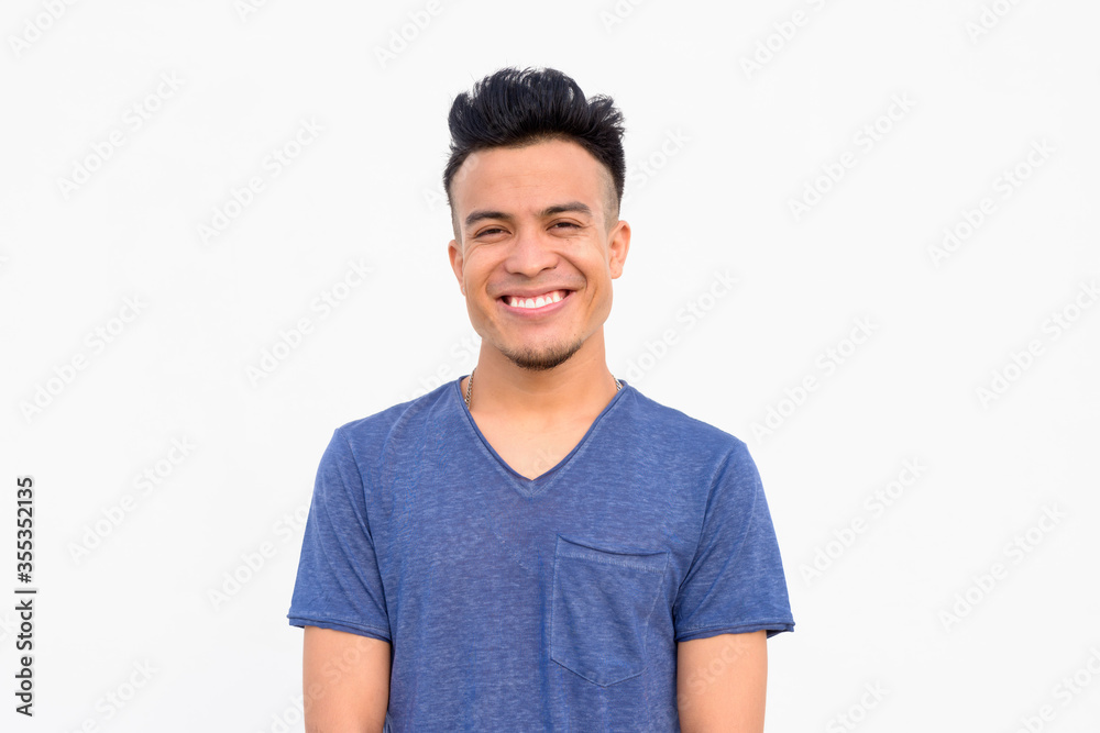 Face of happy young handsome multi ethnic man smiling against white background Face of happy young handsome multi ethnic man smiling against white background