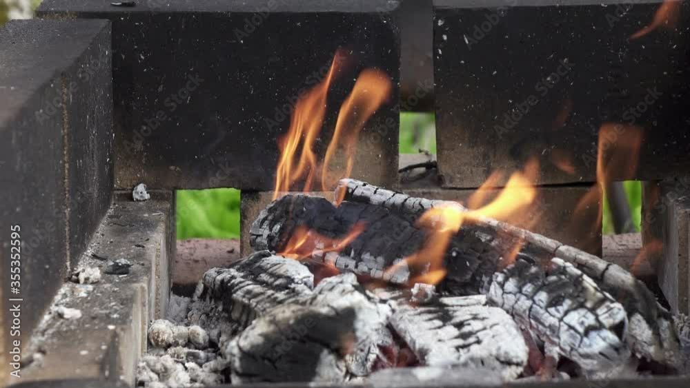 wooden logs burning in a brazier in street,Wooden shelves burn in street mangal on territory of country house, preparation of coals for preparation of barbecues on open fire,BBQ, Shot in 4K UHD wooden logs burning in a brazier in street,Wooden shelves burn in street mangal on territory of country house, preparation of coals for preparation of barbecues on open fire,BBQ, Shot in 4K UHD