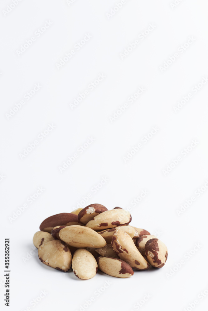 handful of Brazilian walnuton on a white background. close-up of raw nuts. healthy food isolated. copy space for text. handful of Brazilian walnuton on a white background. close-up of raw nuts. healthy food isolated. copy space for text.