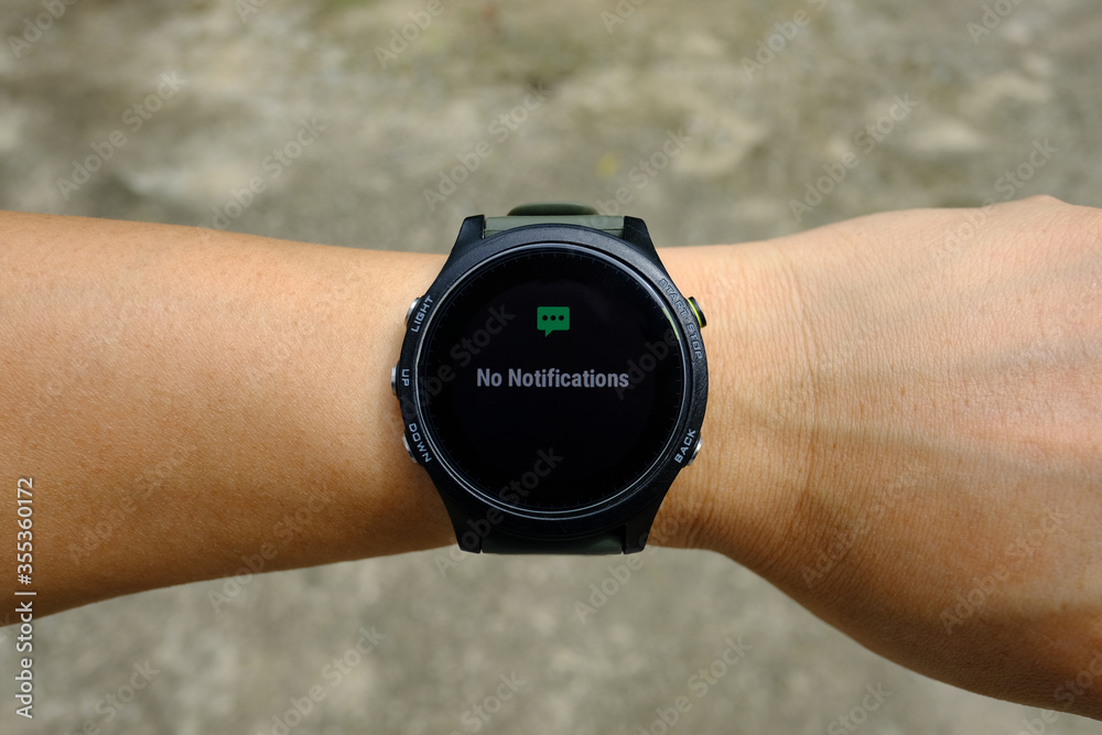 No notification status on modern round-faced GPS multisport digital smartwatch on left hand wrist, selective focus. No notification status on modern round-faced GPS multisport digital smartwatch on left hand wrist, selective focus.