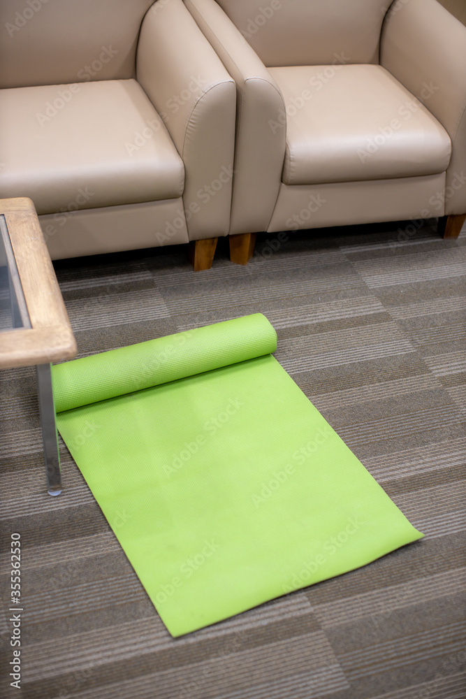 green yoga mat in the office room