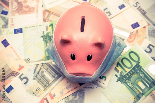 piggy bank in a mask on a background of European currency 