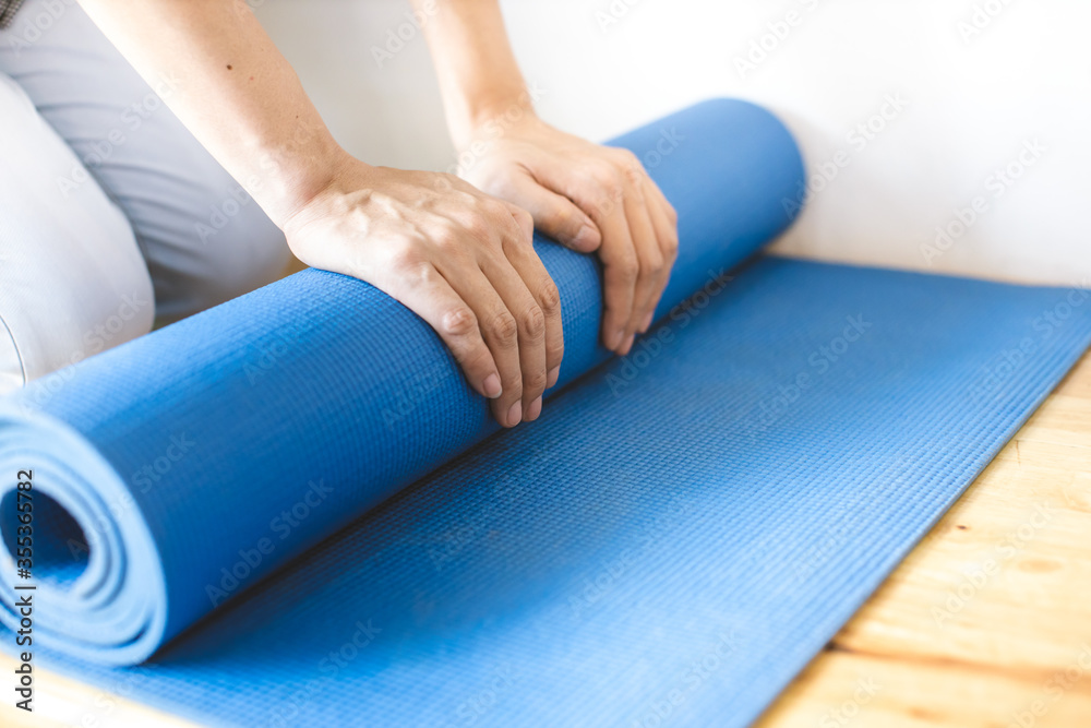 Use both hands to roll the yoga mat.