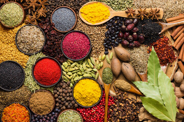 food background, spices and herbs for cooking tasty dishes. various seasonings scattered on table.