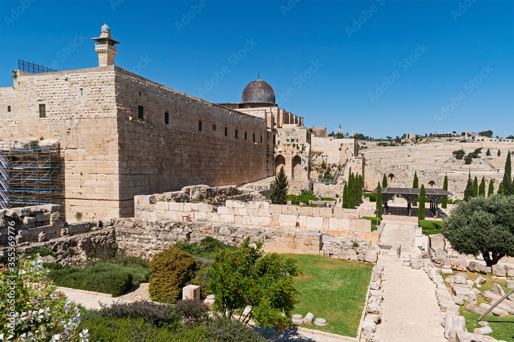 the al aqsa mosque and al fakhria minaret dominate the southern wall of the holy temple mount in Jerusalem with the Mount of Olives in the background